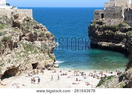 Polignano A Mare, Italy - May 29, 2017: People Visit The Unique Beach Of Polignano A Mare In Apulia,