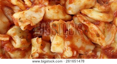 Details Of A Cappelletti Pasta Covered With Tomato Sauce