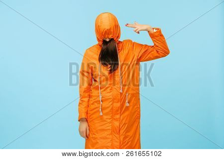 The Young Girl Posing At Studio In Autumn Jacket Isolated On Blue. Human Negative Emotions. Concept 