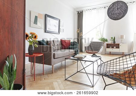 Sunflowers By A Comfy Sofa With Cushions In A Bright Living Room Interior With Diverse Style Of Furn