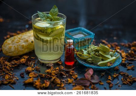 Close Up Of Organic Face Pack Of Cucumber With Aloe Vera Gel And Rose Oil On Wooden Surface In A Gla