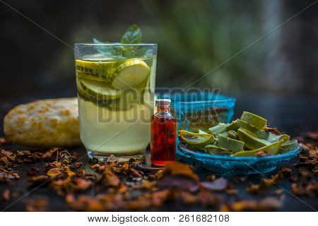 Close Up Of Organic Face Pack Of Cucumber With Aloe Vera Gel And Rose Oil On Wooden Surface In A Gla