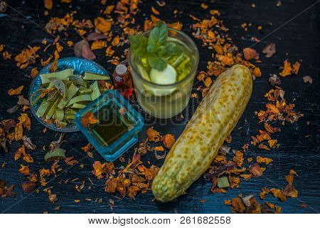 Close Up Of Organic Face Pack Of Cucumber With Aloe Vera Gel And Rose Oil On Wooden Surface In A Gla