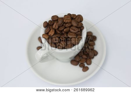 Top View Cup With Coffee Seeds Isolated On White Background
