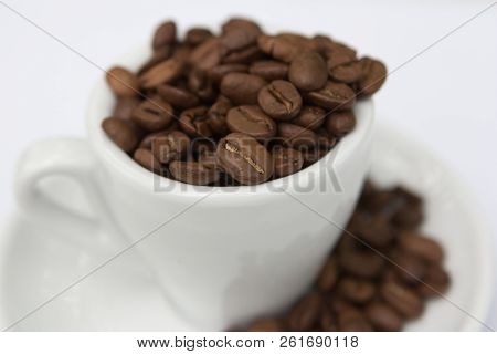 Top View Cup Of Coffee Beans And Seeds