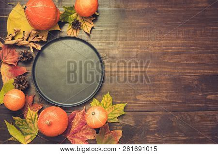 Autumn And Thanksgiving Day Table Setting With Fallen Leaves, Pumpkins, Black Platter And Vintage Cu
