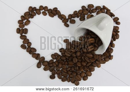 Creative Love Symbol Heart From Coffee Brown Seeds With With Ceramic Cup Top View Isolated On White 