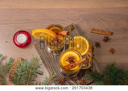 Two Glasses With Delicious Fragrant Tea Of Mulled Wine With Orange And Spices On A Wooden Board With