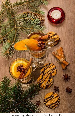 Two Glasses With Delicious Fragrant Tea Of Mulled Wine With Orange And Spices On A Wooden Board With