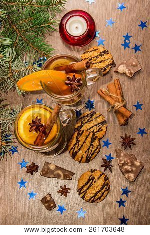 Two Glasses With Delicious Fragrant Tea Of Mulled Wine With Orange And Spices On A Wooden Board With