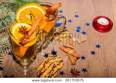 Two Glasses With Delicious Fragrant Tea Of Mulled Wine With Orange And Spices On A Wooden Board With