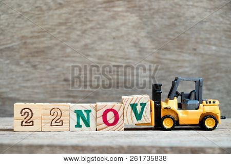 Toy Forklift Hold Block V To Complete Word 22nov On Wood Background (concept For Calendar Date 22 In