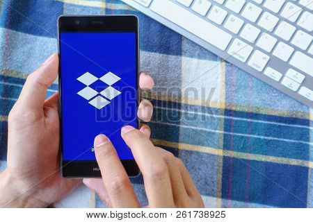 Chiang Mai, Thailand - Mar 28,2018: Man Holding Huawei With Dropbox On Screen. Dropbox Is A Service 
