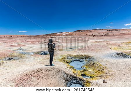 Tourists Taking A Picture Of An Unique Landscape Scenario In Bolivia, Arid Place Around The Geysers,