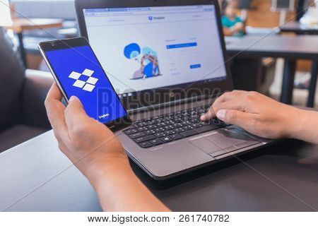 Chiang Mai, Thailand - Mar 18,2018: Man Holding Huawei With Dropbox On Screen. Dropbox Is A Service 