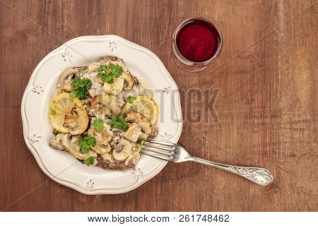 Overhead Photo Of Scallopine Di Vitello, Veal Scallopini, With Mushroom Sauce, Lemons, And Parsley, 