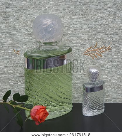 Fragrance For Ladies, Large Perfume Bottle Next To A Commercial Perfume Bottle In Front Of The Satin