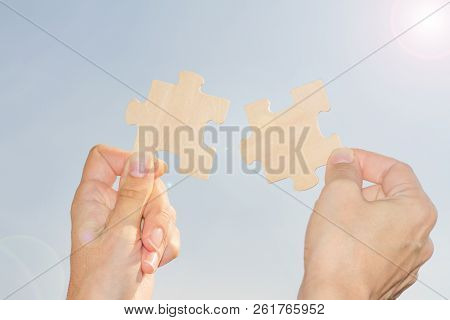 Businesswoman Tries To Solve The Problem Catching Sun Rays Concept With Jigsaw Puzzle And Hands