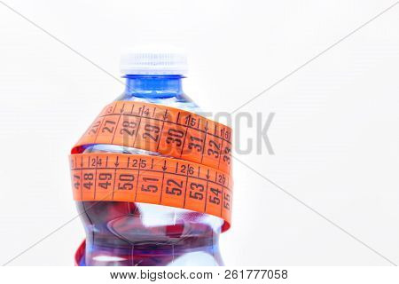 Bottle Of Water And Red Measure Tape