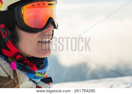 Portrait Of A Snowboarder Woman Freerider In Helmet In Snowy Mountains