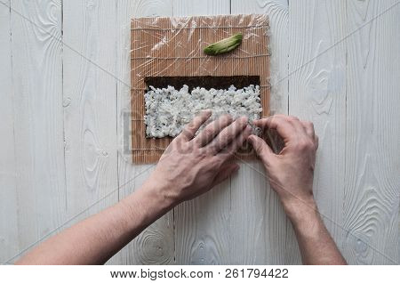 Process Of Making Maki Sushi. Cook Chef Hands Preparing Rolls With Cheese, Avocado And Sesame Seeds 