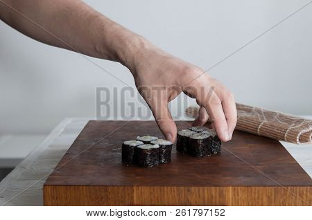 Process Of Making Maki Sushi. Cook Chef Hands Preparing Rolls With Cheese, Avocado And Sesame Seeds 