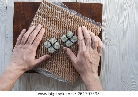 Process Of Making Maki Sushi. Cook Chef Hands Preparing Rolls With Cheese, Avocado And Sesame Seeds 