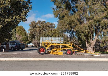 Loxton, South Africa, August 7, 2018: A Street Scene, With An Historic Road Grader And Vehicles, In 