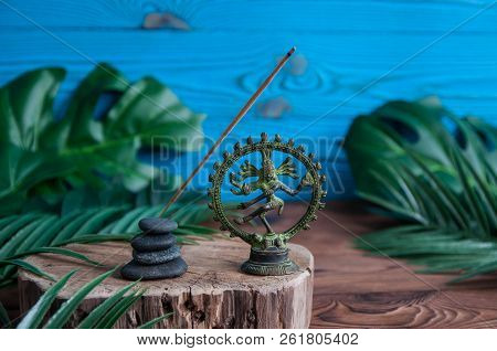 Pyramids Of Gray Zen Stones With Green Leaves And Buddha Statue On Wooden Background. Concept Of Har