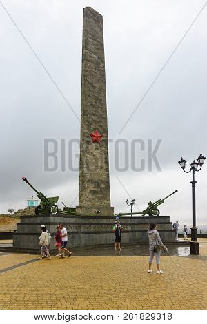 Tourists Near The 24-meter Trihedral Obelisk Of Glory To Immortal Heroes, Dedicated To All The Soldi