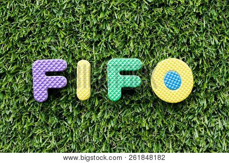 Color Alphabet Letter In Word Fifo (abbreviation Of First In First Out) On Artificial Green Grass Ba