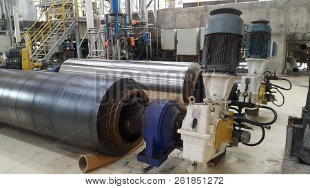 Electrical Parts And Mechanical Parts On Big Gear And Drum Rolls On White Floor