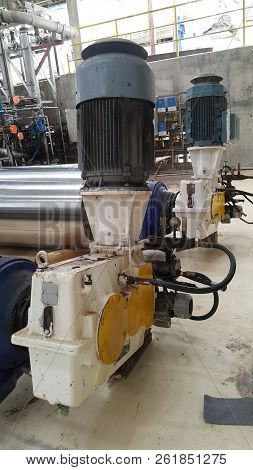 Electrical Parts And Mechanical Parts On Big Gear And Drum Rolls On White Floor