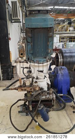 Electrical Parts And Mechanical Parts On Big Gear And Drum Rolls On White Floor