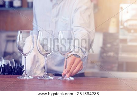 The Bartender Wipes The Wine Glasses. The Waiter Wipes The Wine Glasses. The Bartender Cleans The Gl