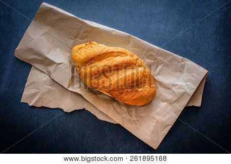 White Bread Rolls On Crafting Wrapping Paper On A Dark Table Background.