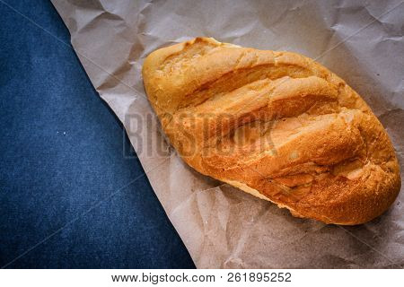 White Bread Rolls On Crafting Wrapping Paper On A Dark Table Background.