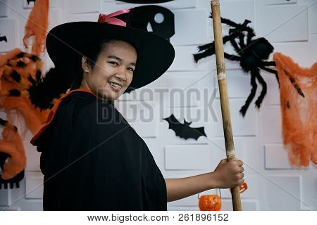 Halloween Wizard And Witch Concept - Cheerful Teenager In Witch Costumes Celebrating Halloween Posin
