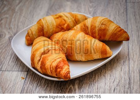 A Rich Variety Of Food Photography Croissant.
Delicious Croissants On A Square White Plate On A Wood