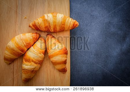 A Rich Variety Of Food Photography Croissant.
Four Croissants On A Wooden Light Cutting Board On Dar