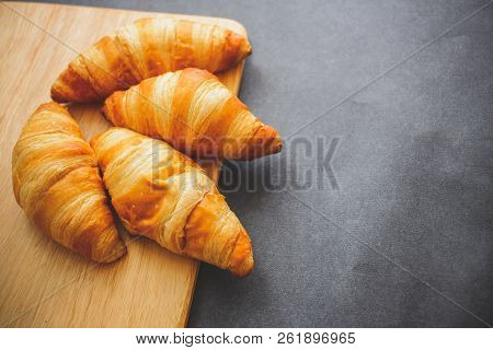 A Rich Variety Of Food Photography Croissant.
Four Croissants On A Wooden Light Cutting Board On Dar
