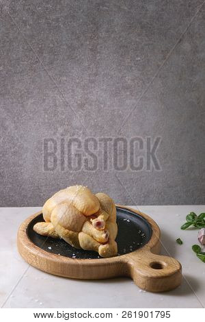 Raw Organic Uncooked Whole Yellow Corn Mini Chicken On Wooden Cutting Board With Salt, Herbs And Gar