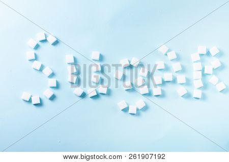 Sugar Word In Sugar Cubes On Blue Background