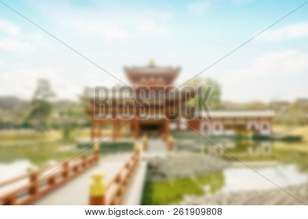 Scenic View And Blurred Of Byodoin Japanese Buddhist Temple With Bridge On Bright Blue Sky Backgroun