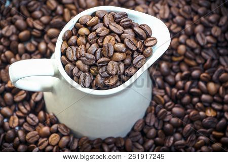 Coffee Beans In The White Mug And Around