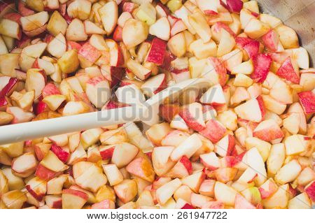 Cook Apple Jam And Stir With A White Plastic Spoon. Process Of Making Apple Jam Marmalade At Home