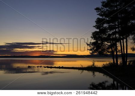 Sunset At The Orsasjon Lake Near The Swedish Town Orsa In The County Dalarna