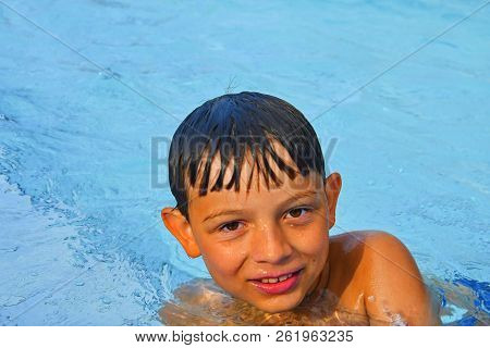 Cute Little Boy In The Public Swimming Pool. Portrait Of Little Cute Boy In The Swimming Pool. Sunny