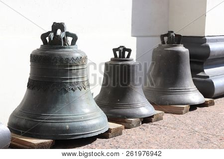 Three Bells On Wooden Planks. Trinity Izmailovsky Cathedral. Cathedral Of The Holy Life-giving Trini