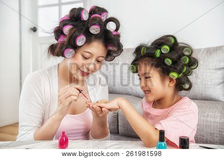 Mom Using Pink Nail Polish Paint Daughter's Nail